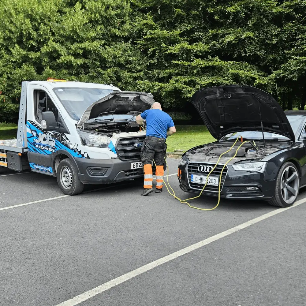 JC Recovery technician jump-starting a car