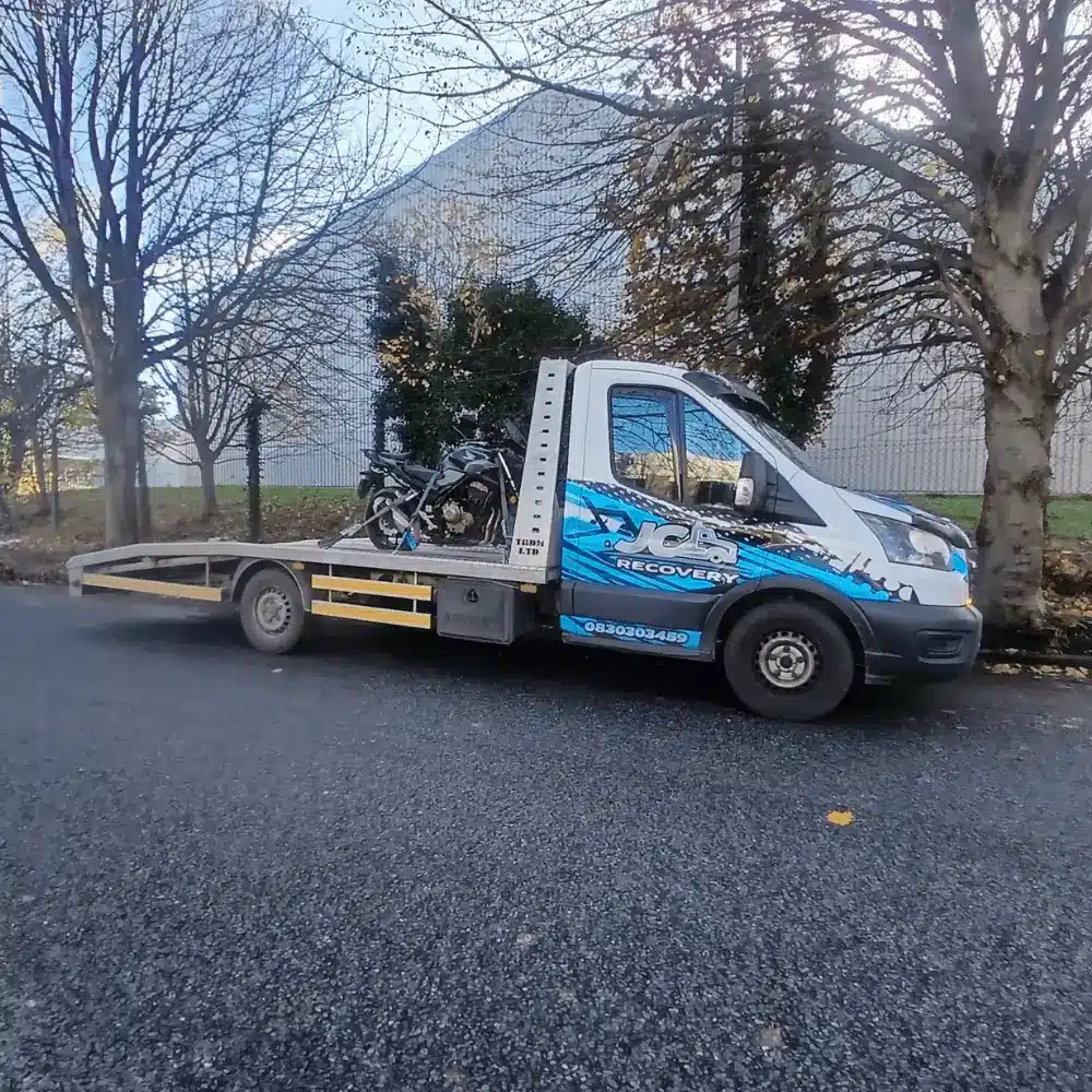 Experienced recovery operator securing a vehicle onto a flatbed tow truck for breakdown recovery in Dublin