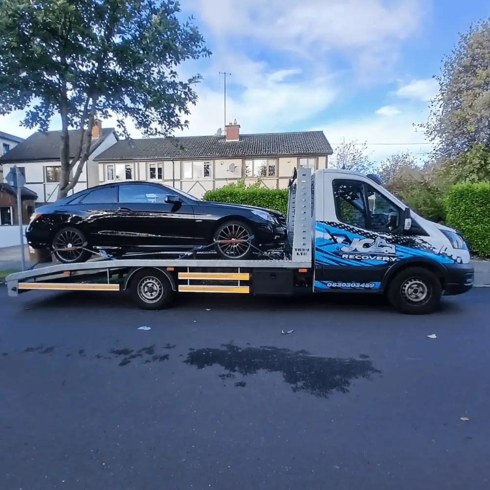 24/7 Tow Truck Dublin recovering a broken-down vehicle using a modern flatbed recovery truck.